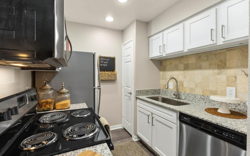 a kitchen with white cabinets